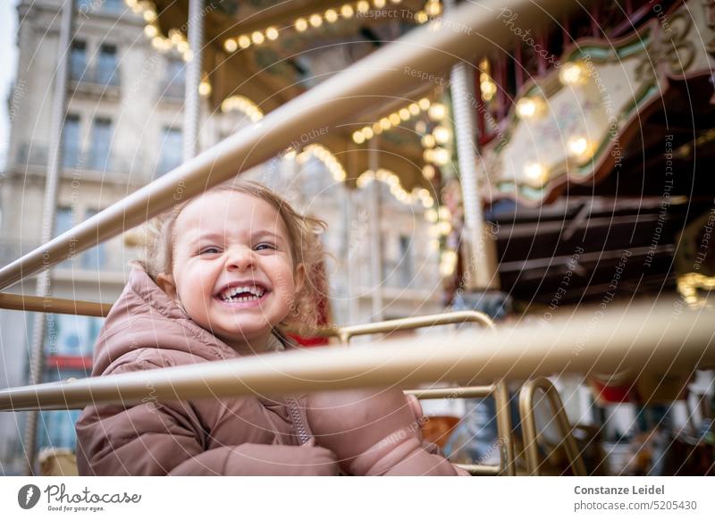 Laughing toddler in children carousel. Joy Toddler Gold Carousel funfair Fairs & Carnivals Laughter Girl pleasure Amusement Park Theme-park rides Attraction