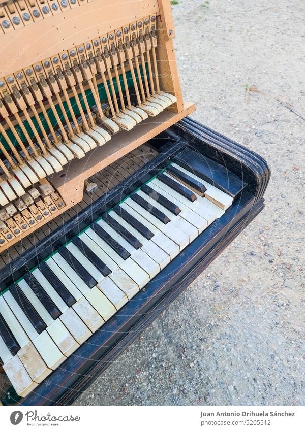 View of a broken old piano traditional concept style ruined broken keys garbage containers abandoned street piano keys obsolete entertainment aged organ grunge