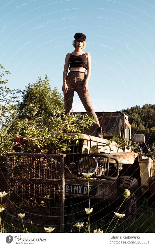 Woman standing on rusty overgrown car Spring Summer Sunlight Uniqueness Authentic Lifestyle Serene closeness to nature Exterior shot Day 18 - 30 years