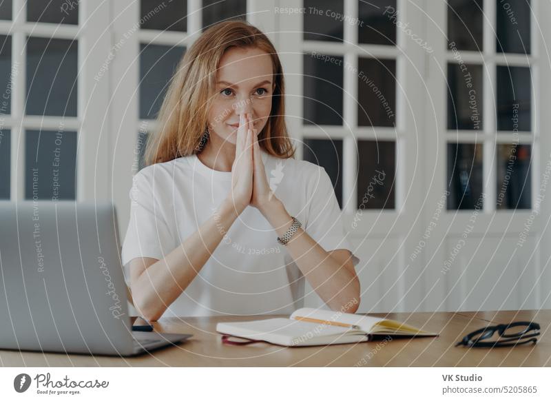 Sophisticated woman sitting with her hands folded and relaxing. Concept of confidence and success. sophisticated sophisticated woman desire meditating eye
