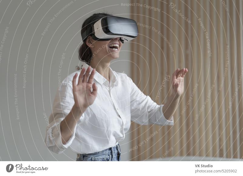 Impressed amazed female office worker using VR glasses while working in augmented reality world virtual woman employee vr businesswoman headset goggles touch 3d