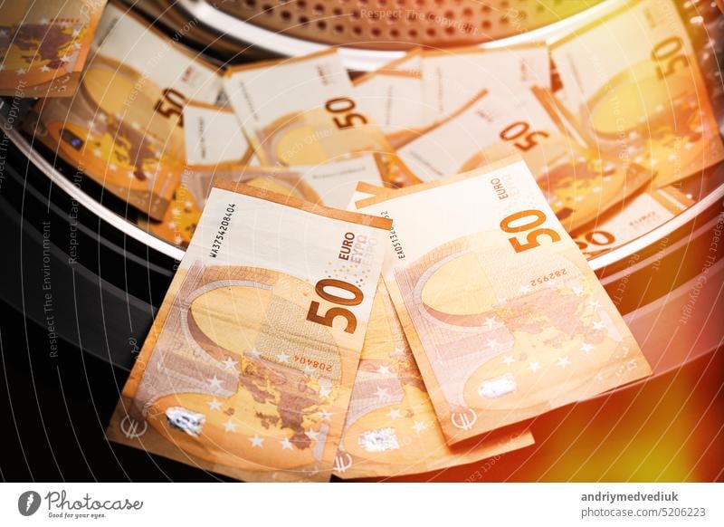 Money laundering symbol, 50 euro banknotes inside washing machine. Tax evasion. Illegal financial transactions. Euro currency business laundry money economy