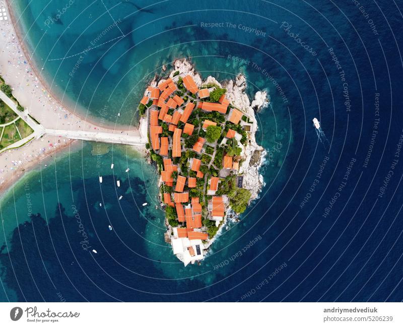 Aerophotography. Aerial view of Sveti Stefan island in a beautiful summer day, Montenegro from flying drone. Panoramic above view of Saint Stephen luxury resort. Tourism and leisure concept.