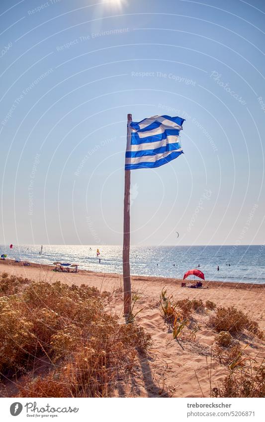 Greek national flag on the beach of Corfu, a Greek island in the Mediterranean Sea symbol Flag Greece National country background Banner Emblem Blue Europe