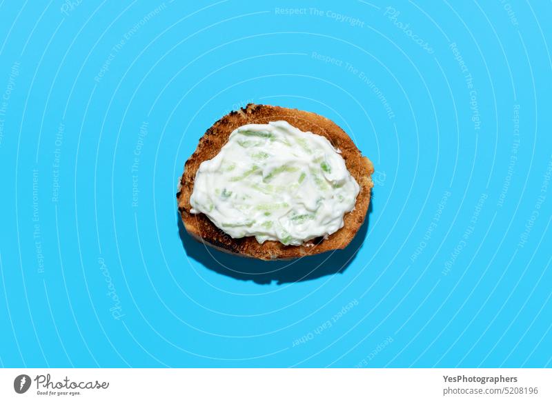 Tzatziki sauce on toasted bread, above view on a blue background appetizer breakfast bright cacik color copy space cream cucumber cuisine cut out dairy