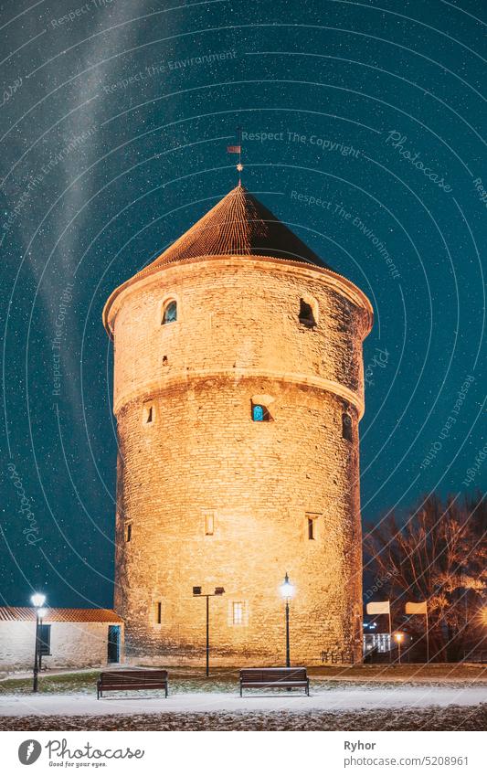 Tallinn, Estonia. Night Starry Sky Above Traditional Old Architecture Skyline In Old Town. Medieval Tower Kiek-in-de-Kok In Winter Park On Hill Toompea. Famous Landmark. Altered Sky With Stars