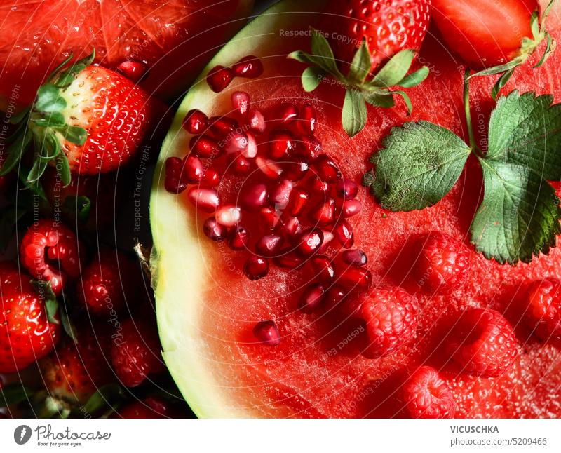Close up of red juicy fruits: watermelon, strawberries, pomegranate . Top view close up top view summer delicious raspberry strawberry closeup healthy sweet