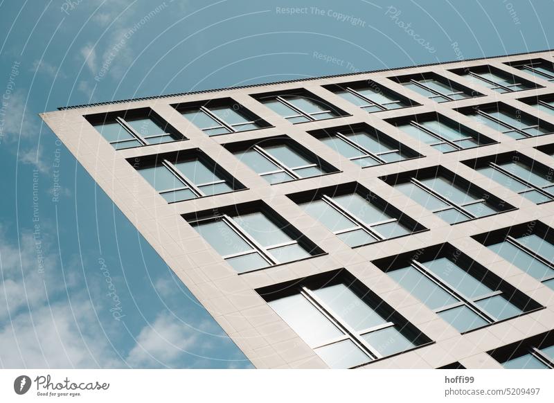 Windows on confusingly flat diagonal facade against blue sky, Modern architecture modern Geometry Deception disheveling futuristic Flat Flat view shape Illusion