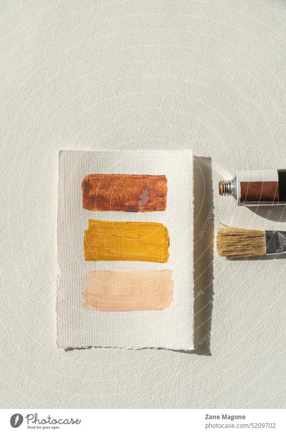 Minimalist flat lay with warm earthy color palette and painting tools, beige background flatlay summer artist neutral terracotta sunny styled painting lessons