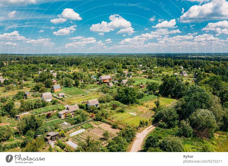 Aerial View Of Small Town, Village Cityscape Skyline In Summer Day. Residential District, Houses And Vegetable Garden Beds In Bird's-eye View landscape
