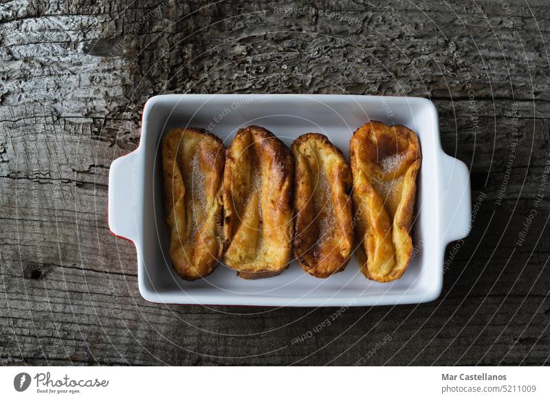 Torrijas. Typical food of Spain at Easter. Copy space. process bread wooden background rustic copy space rustic wood top view dessert sweet container tray