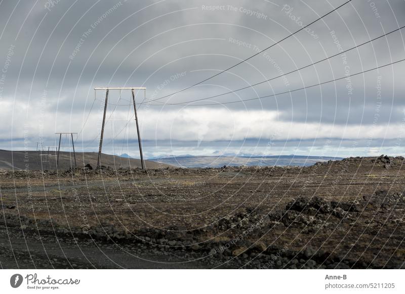 Electricity in Iceland comes exclusively from renewable sources, mainly from hydroelectric power plants. Here pylons and lines that lead through a very barren lava landscape