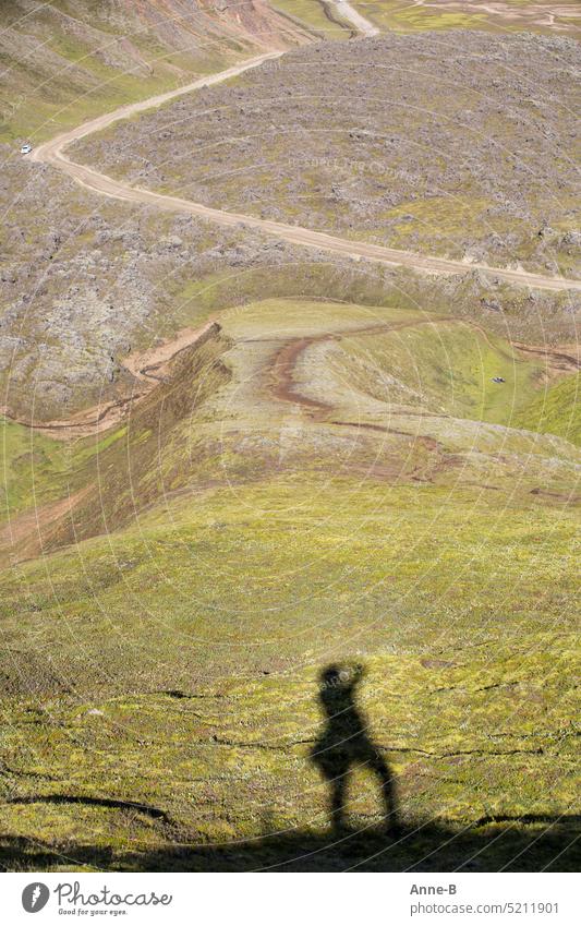 Travel photography , shadow of photographer on a mountain overlooking a lava landscape Landscape bizarre Lava Lava landscape Shadow Take a photo