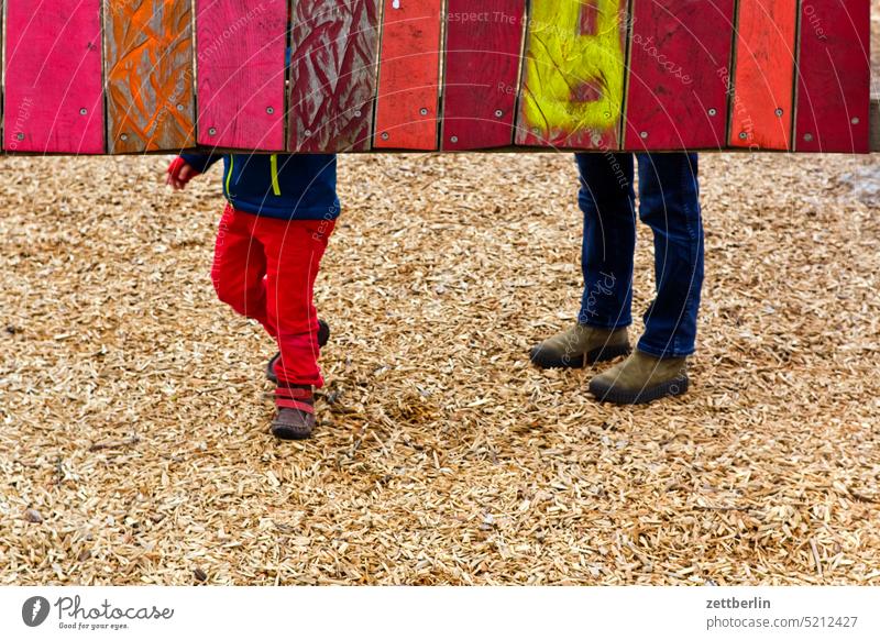 Grandson and grandma on the playground Playground Sand place Child more adult Human being child granny Grandchildren Feet leg Pants Wall (building) Wood