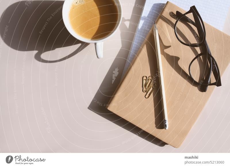 aesthetic minimalist workspace. Home office, blog, social media concept. Note book, coffee and glasses in soft pastele colors modern home background design