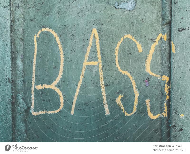 The word "BASS" was written in bright yellow on a gray-green facade bass Graffito writing Word Music Musical instrument Characters Facade Daub Typography