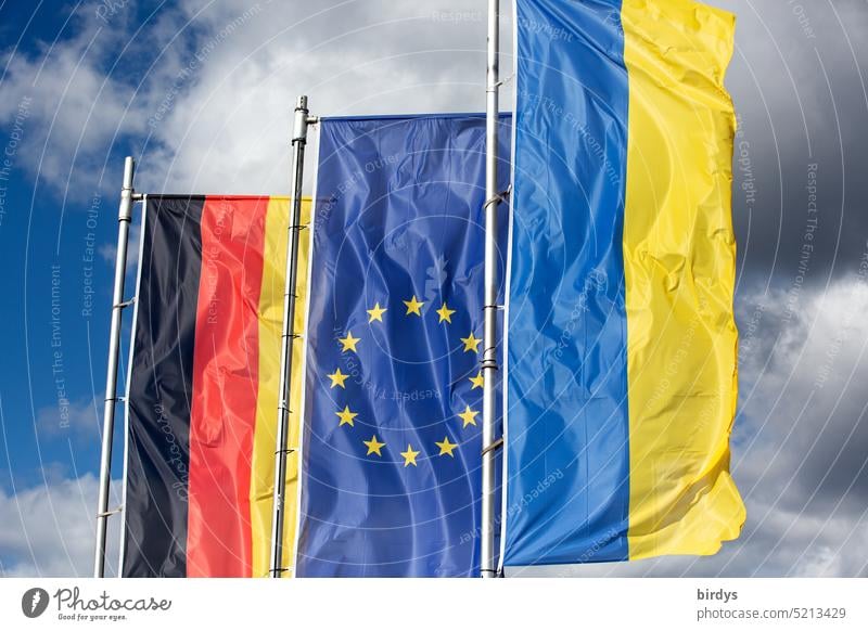 Germany flag , EU flag and Ukraine flag flying side by side in the wind Ukraine war German flag European flag Side by side European Union Attachment Solidarity