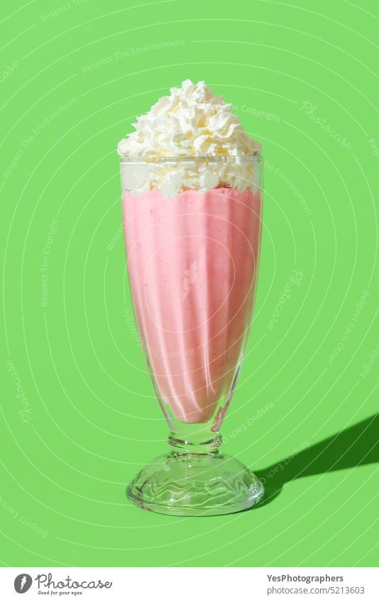Strawberries milkshake glass in bright light, isolated on a green background american beverage cocktail cold color copy space cream cuisine cup cut out dairy
