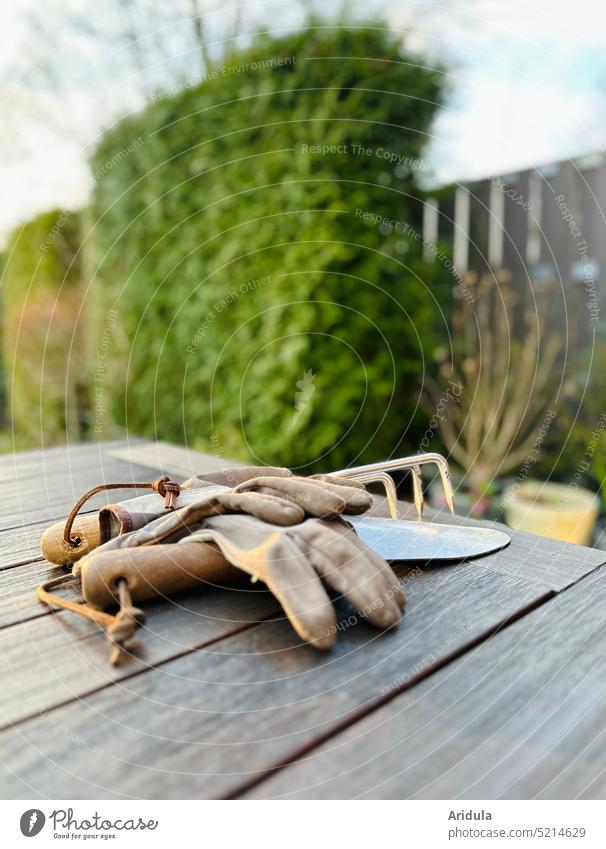After gardening | gloves and tools are on the garden table Garden Gardening Spring gardening gloves Shovel Trident rest Table do gardening Earth blurred Hedge