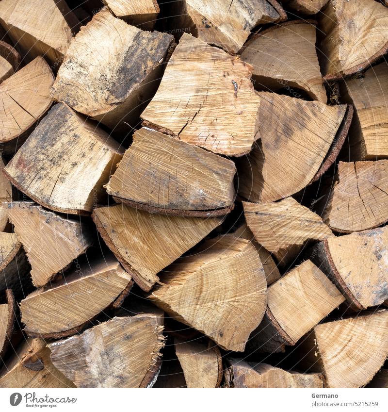 A stack of dried firewood pile woodpile cut timber chopped log dry energy background stacked closeup detail heap rustic logs oak hardwood split nature tree