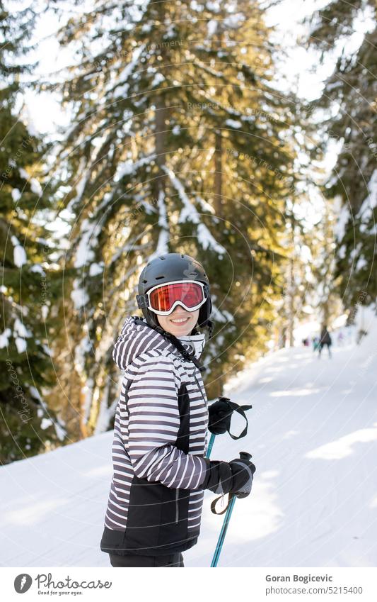 Young woman enjoing winter day of skiing fun in the snow clothing cold temperature leisure activity mountain one person sports sports equipment tree vacation