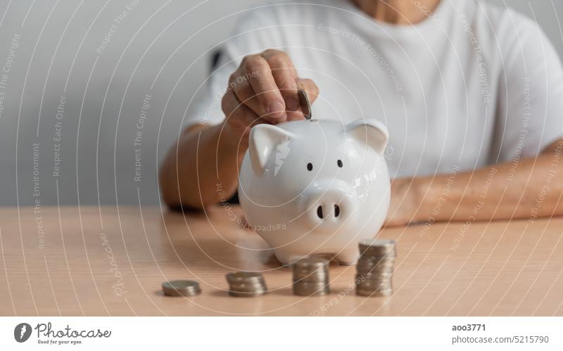 Woman who puts coins in a piggy bank and saves money for future planning and retirement, earns or invests money, or pays taxes for a business concept. savings