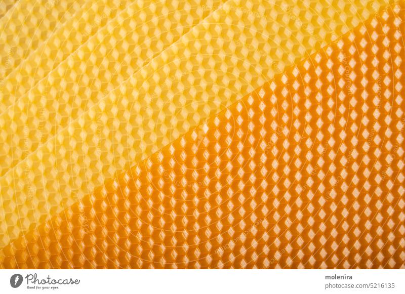 Beeswax honeycomb sheet background beeswax candle material close up cell yellow beehive texture surface pattern nature