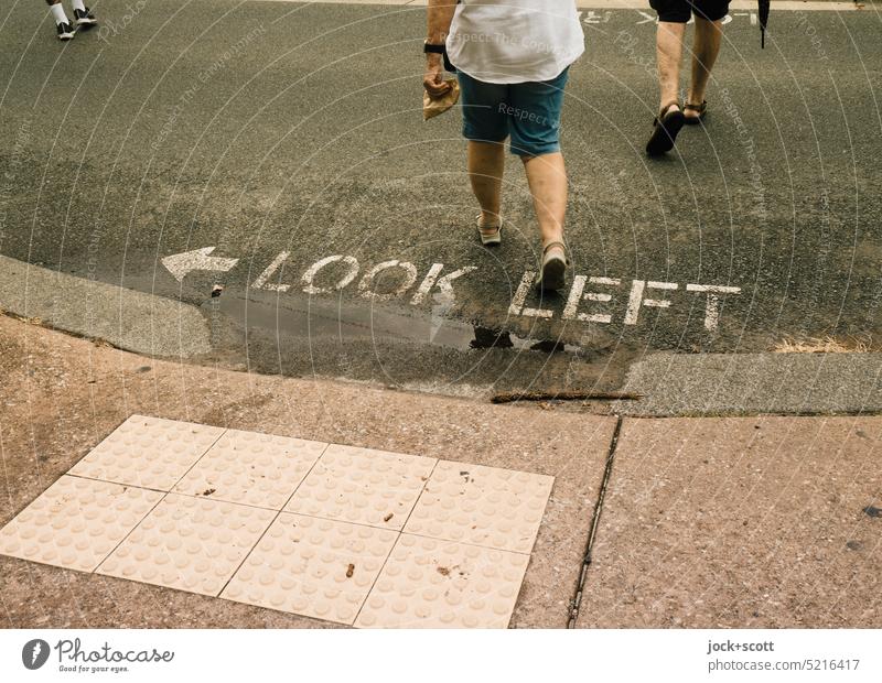 Look LEFT before crossing the road look to the left Word English Street Sidewalk Capital letter Neutral Background Pedestrian Characters Traverse Going