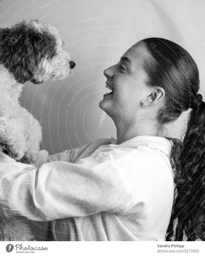 Young woman with small dog Human being Dog Puppy Animal portrait Cute Laughter Joy Connectedness Happiness Love of animals hair Pelt black and white Pet Looking