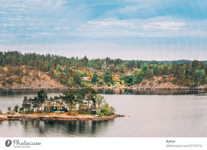 Sweden. Many Beautiful Swedish Wooden Log Cabins Houses On Rocky Island Coast In Summer Day. Lake Or River Landscape sweden house huts hygge travel nature