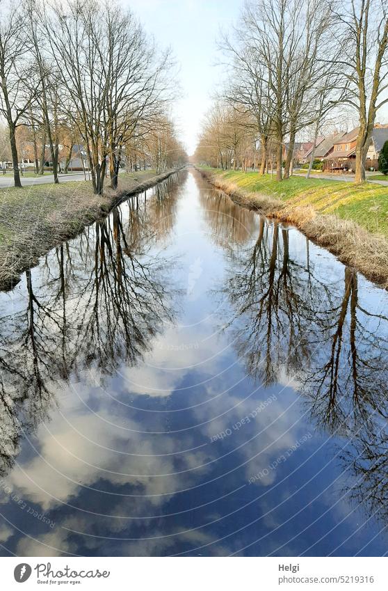 Trees reflected on both sides of a small channel in fine weather Channel Water reflection Avenue spring Beautiful weather Sky Clouds Nature Landscape