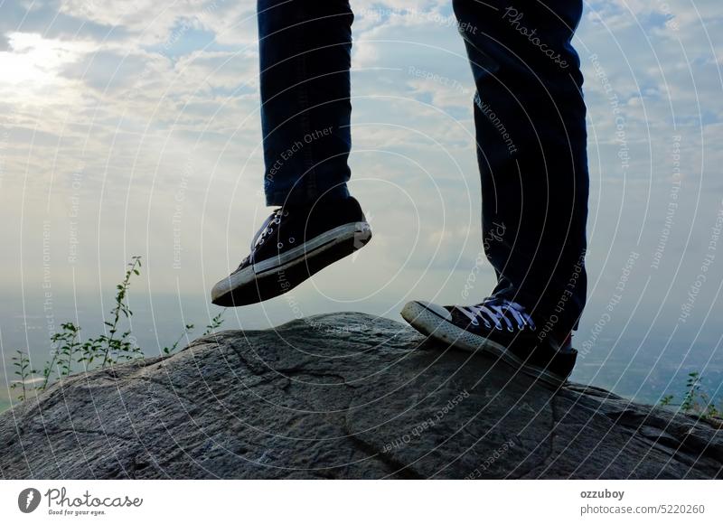 Low section of young man with kicking pose on the rock person sport foot lifestyle cool fit game guy human play posing standing boy male active fashion view