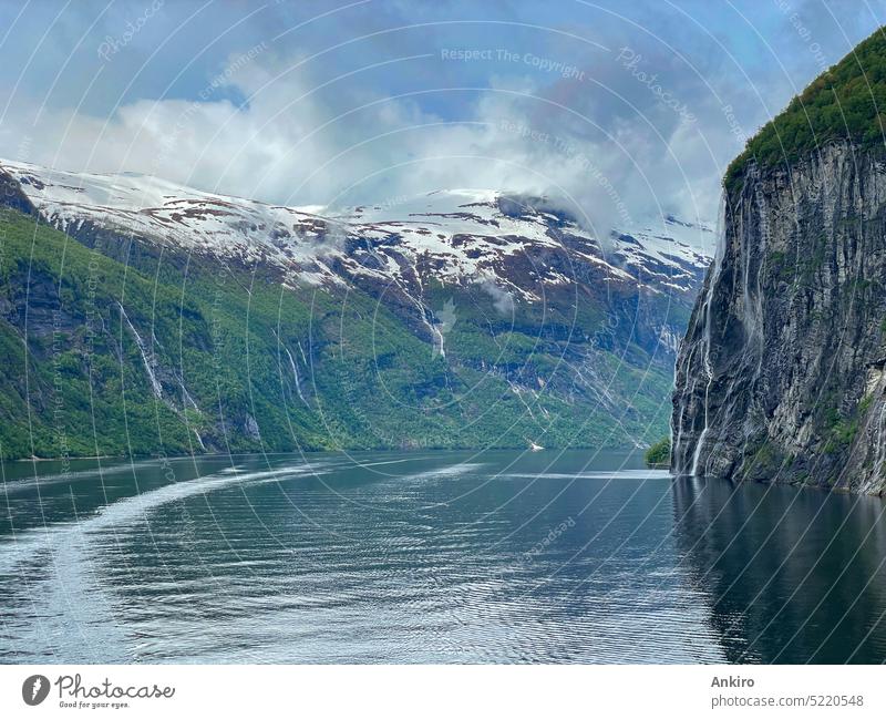 In the beautiful Geiranger Fjord in Norway sky fjord geirangerfjord norway north sea blue norwegian mountain travel tourism nature water landscape clouds