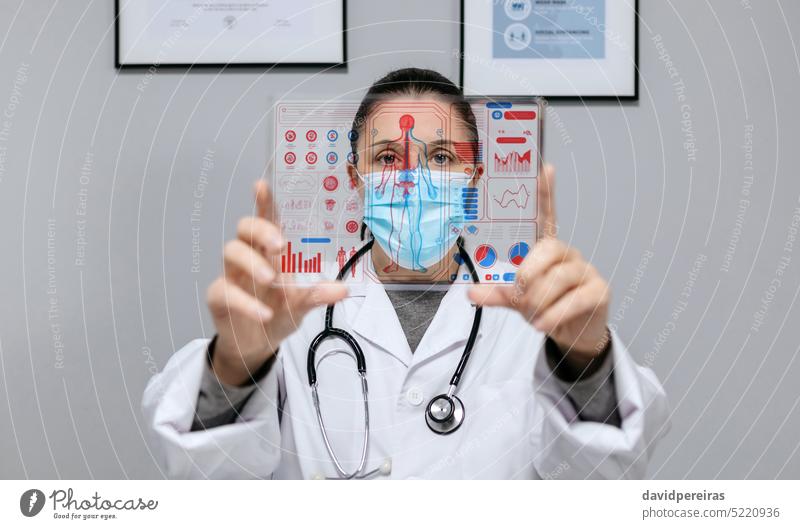 Female doctor looking at transparent tablet with medical digital diagnostic screen woman hud ui display futuristic technology interface health care healthcare