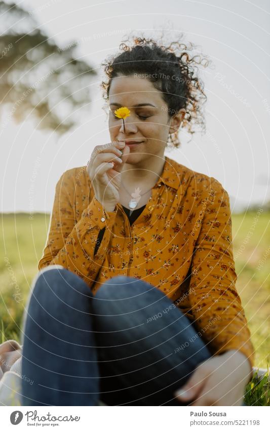 Beautiful woman holding Yellow flower Woman Curly hair people curly beauty beautiful portrait lifestyle casual Adults young curly hair Meadow Flower Spring