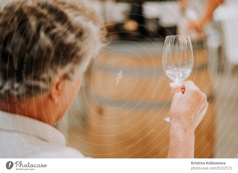 Mature man drinks white wine in glass,tasting winery production in store factory alcohol red happy young background beverage celebration party restaurant taste