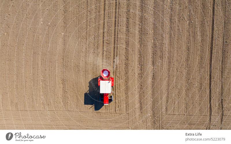 Aerial view on tractor as spread fertilizer over agricultural field Above Agriculture Arable Artificial Barley Care Cereal Chemical Country Crop Cultivated