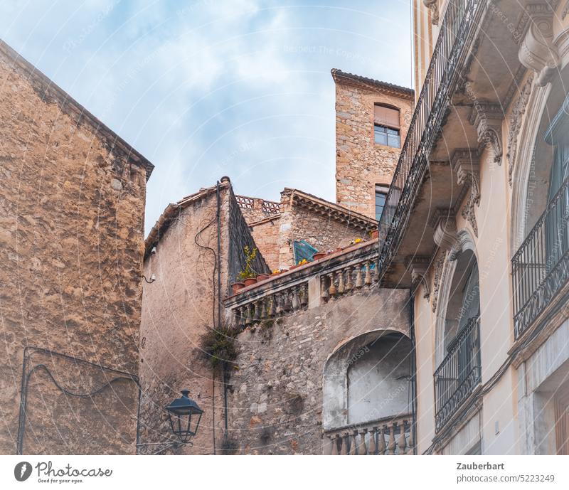 Stone houses, balconies and facades in brown, historical townscape in Catalonia stone house Facade Balcony Town Cityscape Historic Spain Old museum pretty