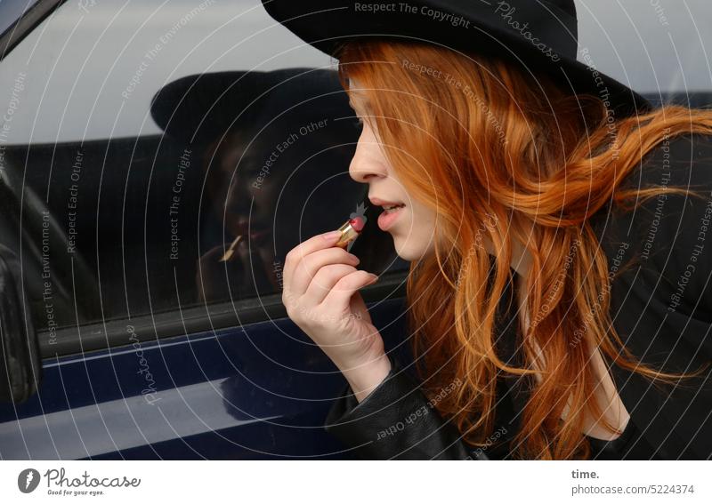 redhead woman with hat putting makeup on car side mirror portrait Woman Concentrate Life Calm Patient Serene Conscientiously Watchfulness pretty Observe