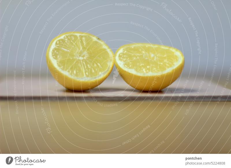 two sliced lemons cast shadows on a cutting board in pink. Lemons Sour Sliced Shadow Chopping board Table Food Fresh Nutrition Close-up Yellow Healthy Vitamin C