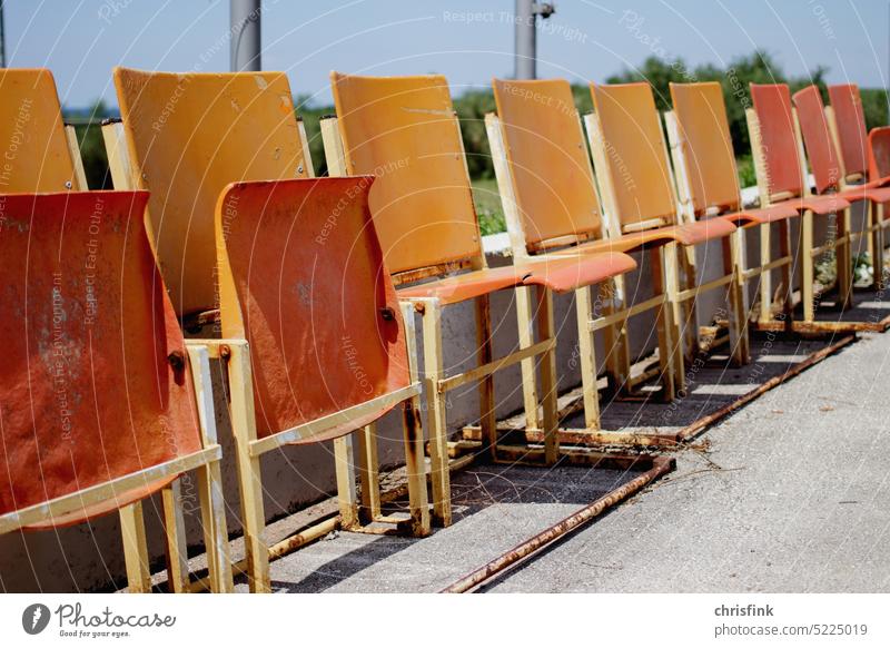 Folding chairs fixed to wall Chair Sit Seat Bench Furniture Deserted Seating Break Arena spectators Concert Seating capacity Row of seats Row of chairs Places