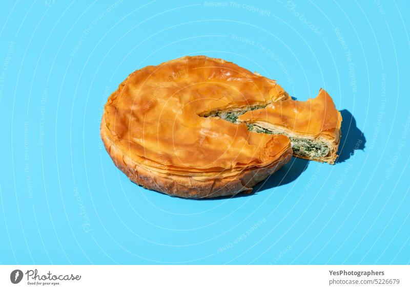 Phyllo spinach pie isolated on a blue background. Savary pie with spinach and cheese baked balkan banitsa bosnian bright bulgarian cake color cuisine culture