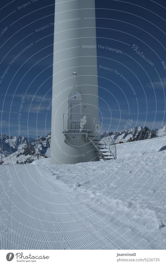Snow landscape with windmill tower door Environmental protection Future Energy industry Climate change Technology Winter Mountain Energy crisis Electricity