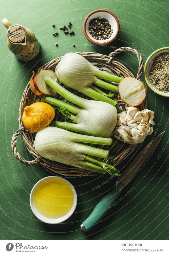 Cooking preparation of fennel on green background with ingredients and kitchen utensils, top view. Healthy food cooking healthy food bowl herb recipe vegetable