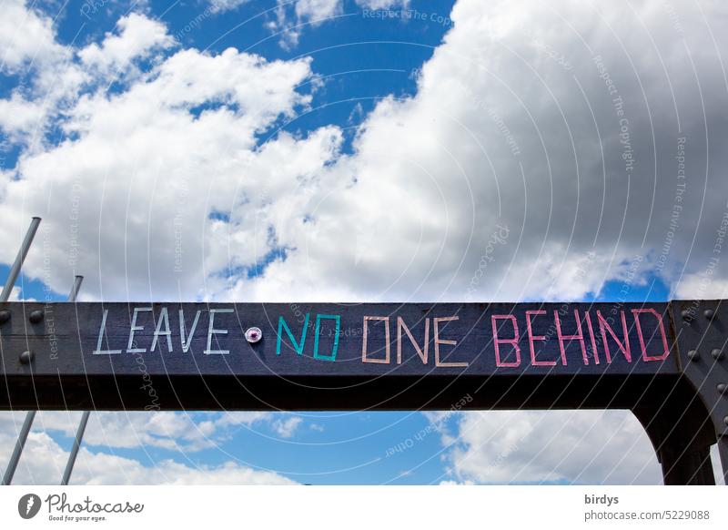 Leave no one behind. Colorful lettering on a steel beam Refugee helping refugee aid leave no one behind Characters War Humanity Human rights Responsibility