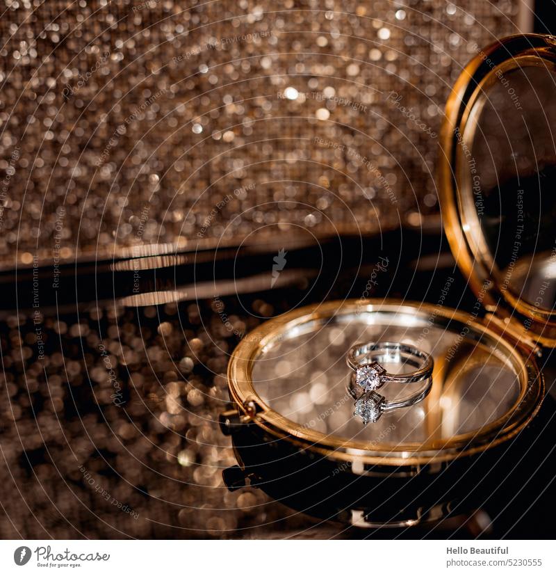 Ring on a mirror in front of a golden handbag Mirror Betrothal engagement ring Wedding Gold sparkle glittering glamorous Glamor glamour girl Money Luxury