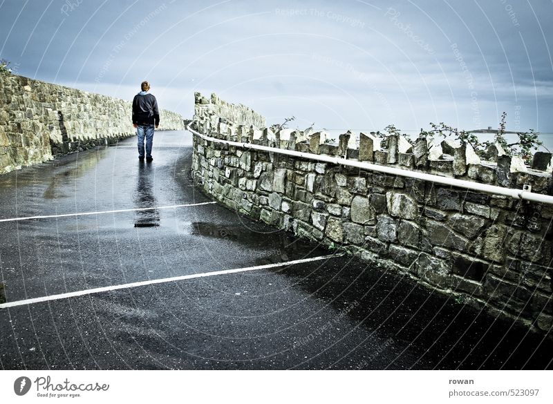 After the rain Human being Masculine Man Adults 1 Lanes & trails Wet Wall (barrier) Stone wall Stand To go for a walk Rainwater Asphalt Loneliness Individual