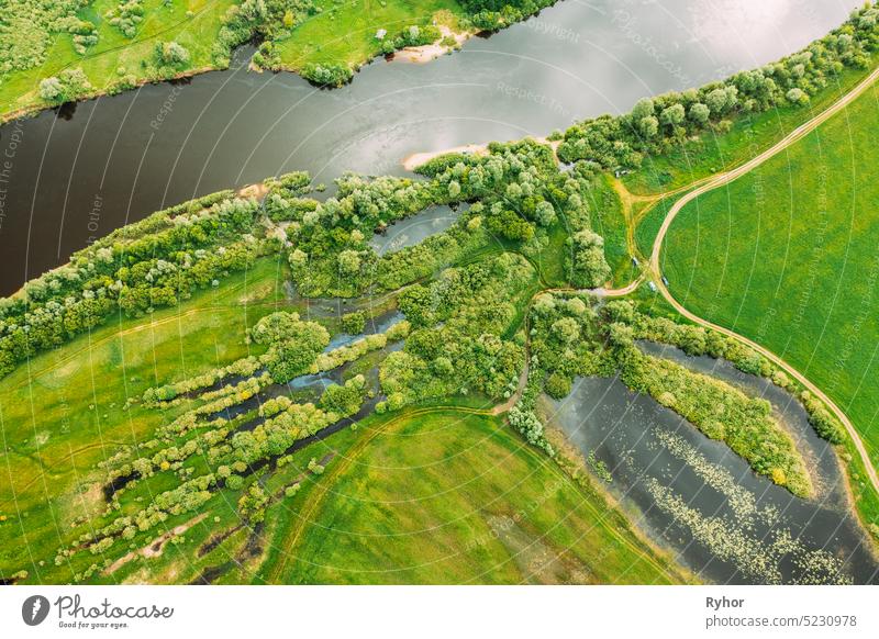 Aerial View Of Green Forest, Meadow And River Marsh Landscape In Summer. Top View Of European Nature From High Attitude In Spring. Bird's Eye View Of Flood Of River In Spring. Flat View