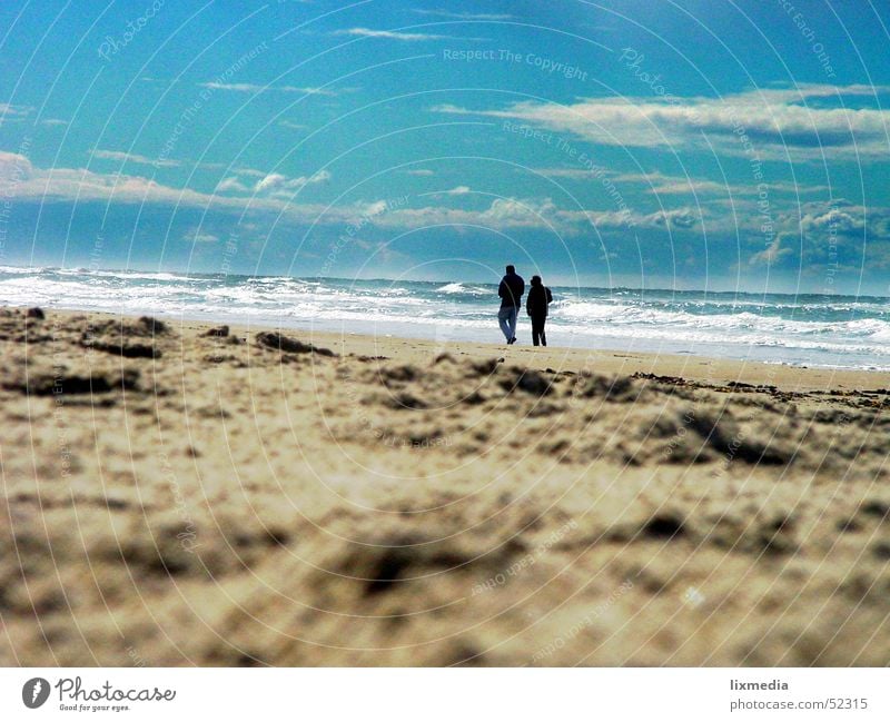 on the beach alone in pairs Beach Ocean Waves To talk Human being Woman Adults Man Couple Nature Sand Sky Clouds Together Longing 2 To go for a walk Surf