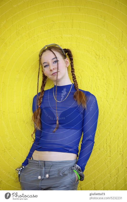 Raver girl - styled with braids in cool blue techno outfit in front of yellow wall portrait blue-yellow favourite person 13 - 18 years 18-25 years